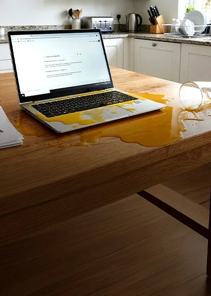 Woman working at desk at night using phone and laptop with Optimum Mobile and Fiber bundle