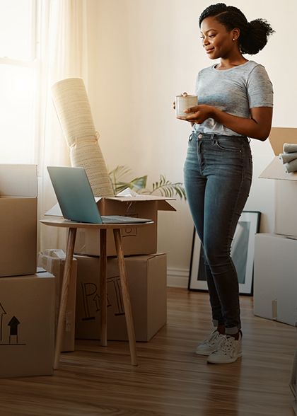 Woman on tablet in new home setting up Optimum Fiber Internet for the first time