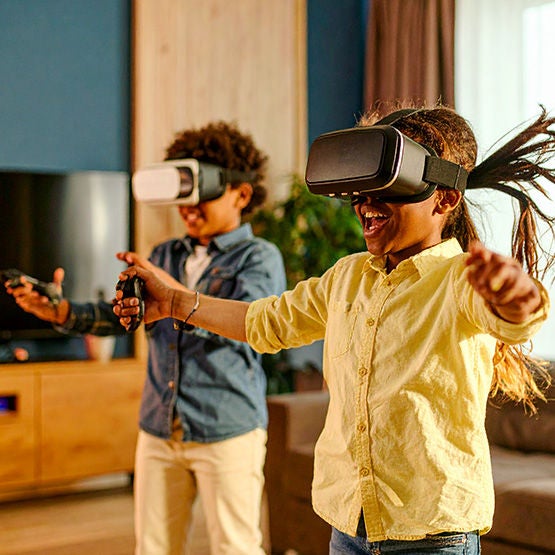 Two kids playing a virtual reality game using Optimum Fiber Internet