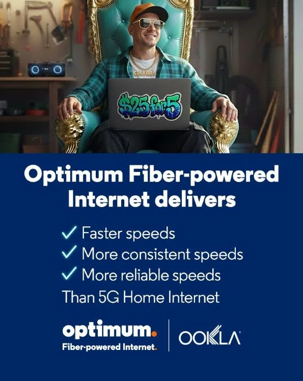 A young woman having a cup of coffee while on her laptop listening to either music or streaming a movie with her headphones on while surfing the Internet using Optimum Fiber Internet.