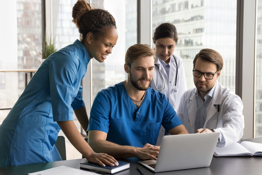 Group_of_Doctors_Reviewing_Medical_Records_on_Laptop