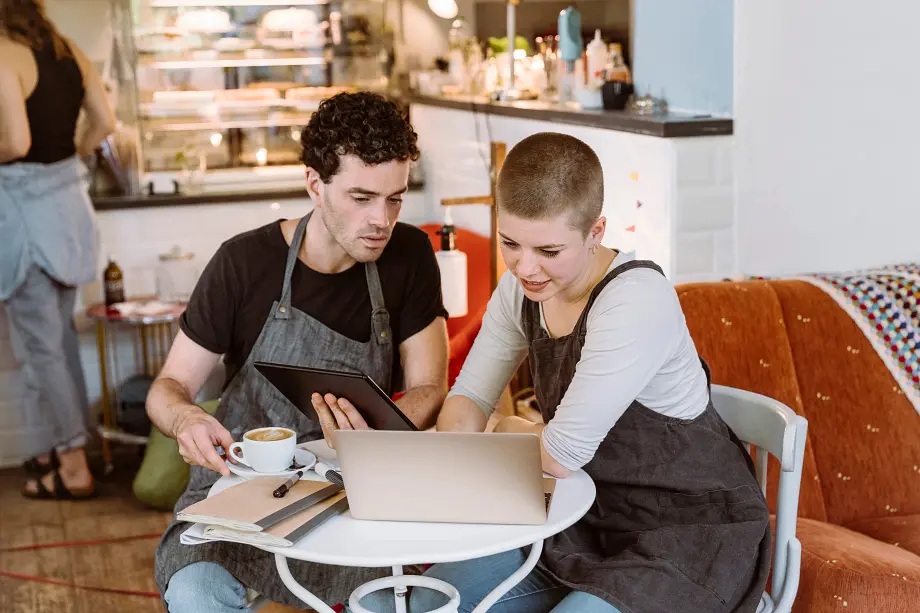 Male and Female Co-Workers looking at laptop.