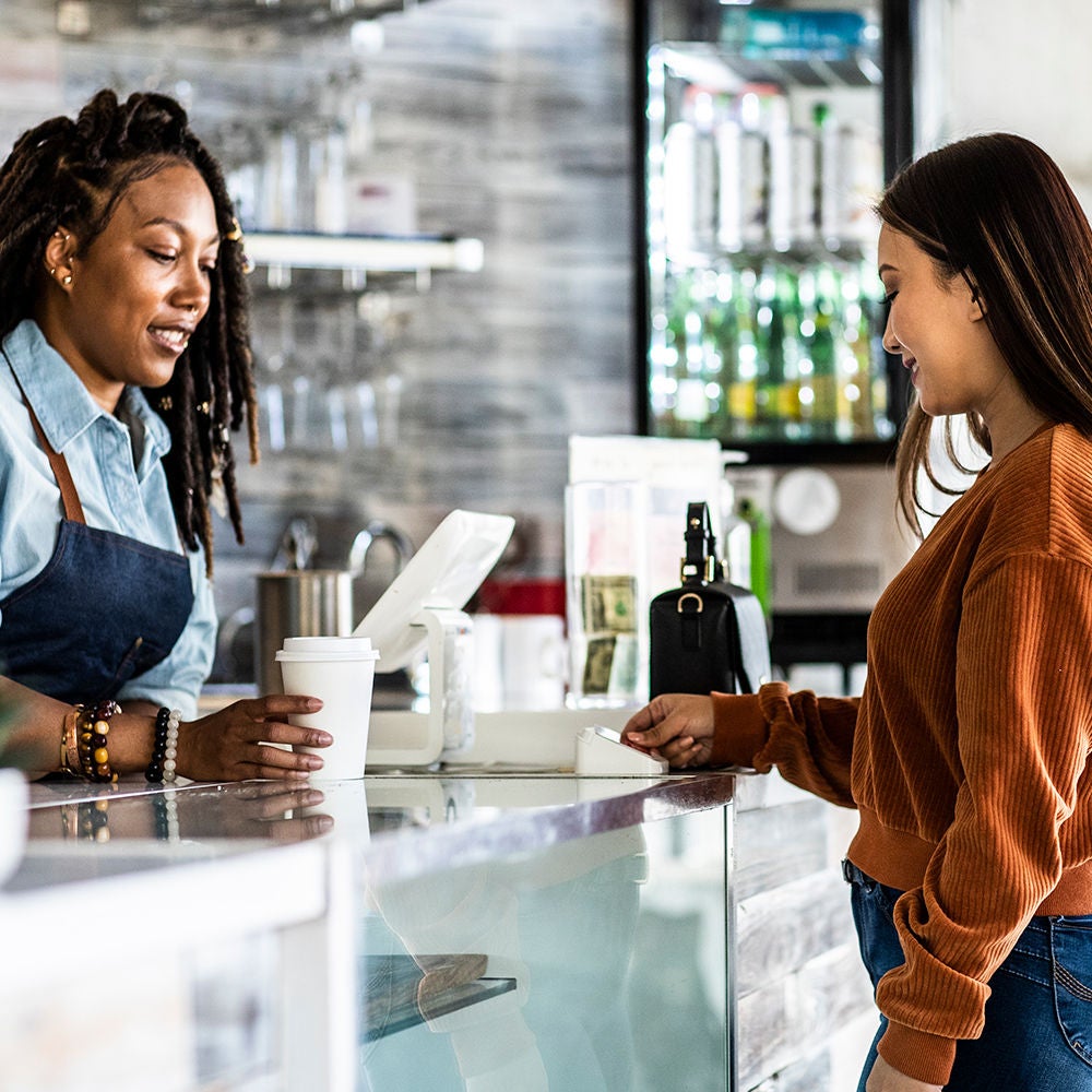 Image depicting a woman paying for her items at a retail checkout, illustrating the concept of backup solutions in a business context.
