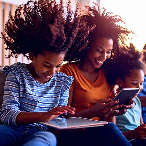Family using Optimum Internet on tablet, laptop, and mobile phone