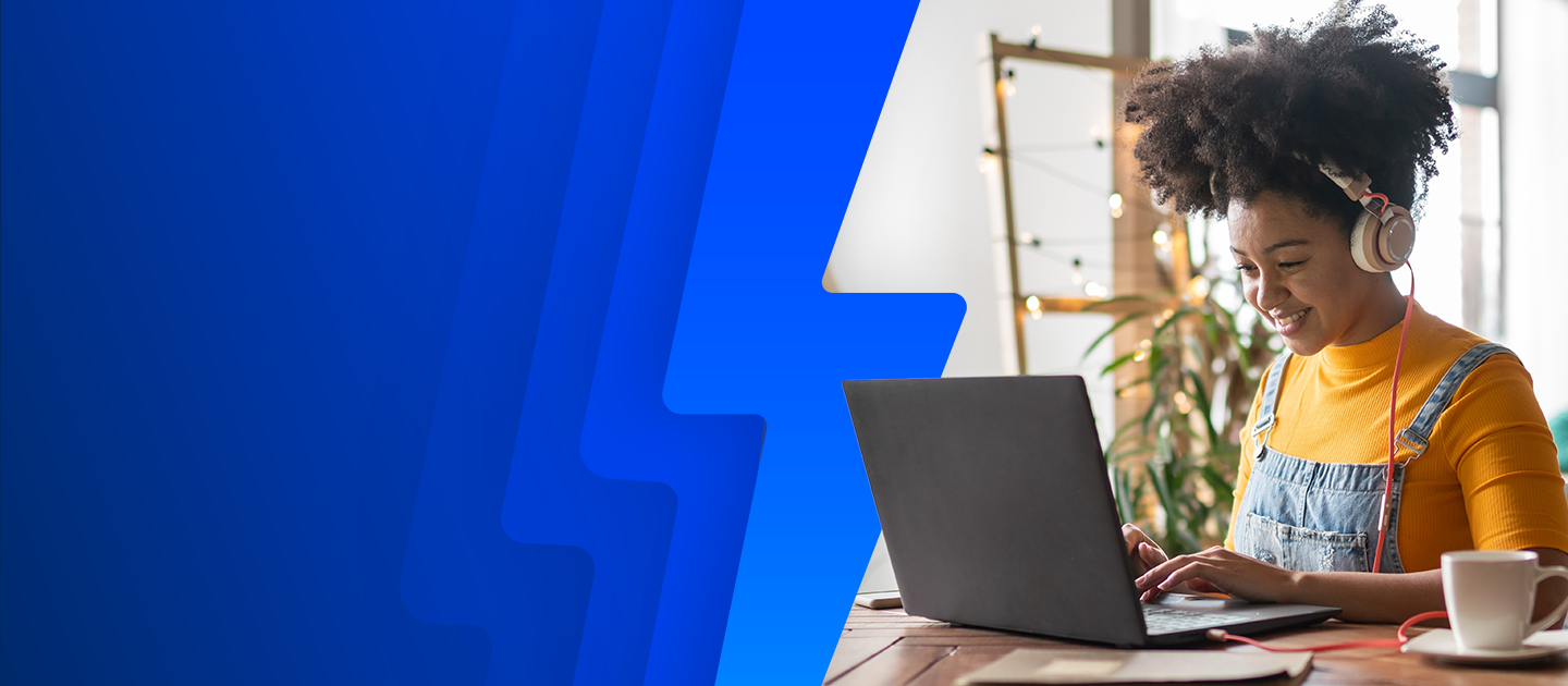 A young woman having a cup of coffee while on her laptop listening to either music or streaming a movie with her headphones on while surfing the Internet using Optimum Fiber Internet.