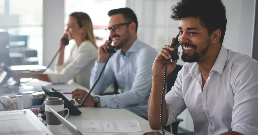 Three workers on the phone making calls