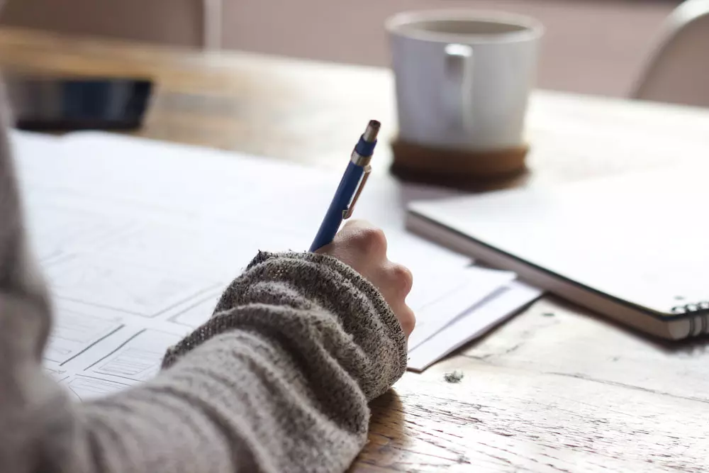 Small business owner taking notes at a desk