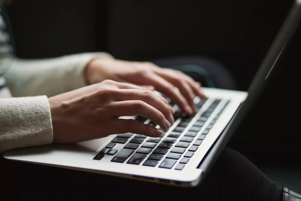 person typing in the dark