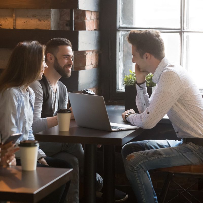 Group discussion in a coffee shop representing guest and private WiFi networks.