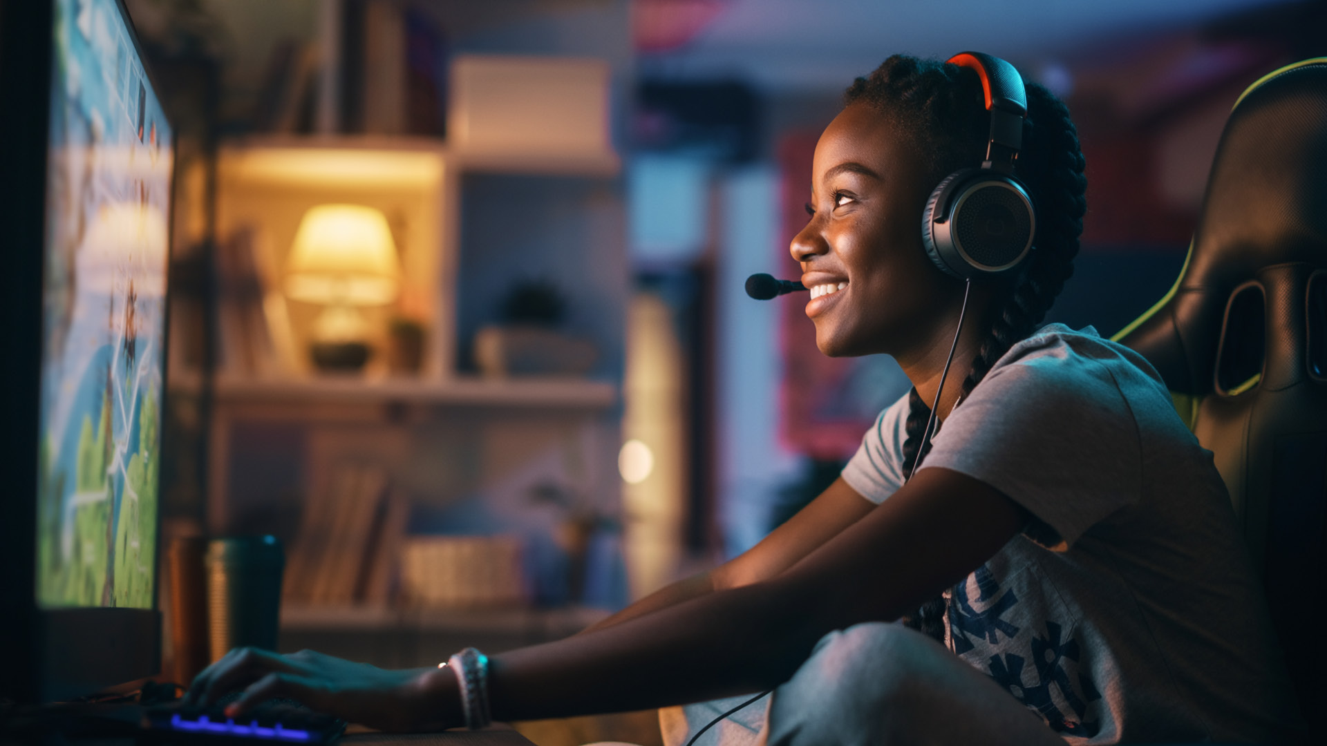 A gamer wearing a headset plays an online game on a desktop PC, illustrating a fast, low-latency internet connection designed to help lower ping for smoother, more responsive gameplay.
