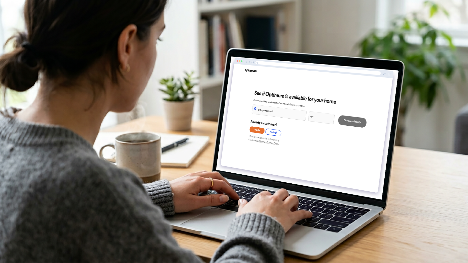 Woman checking Optimum Internet Availability on her laptop