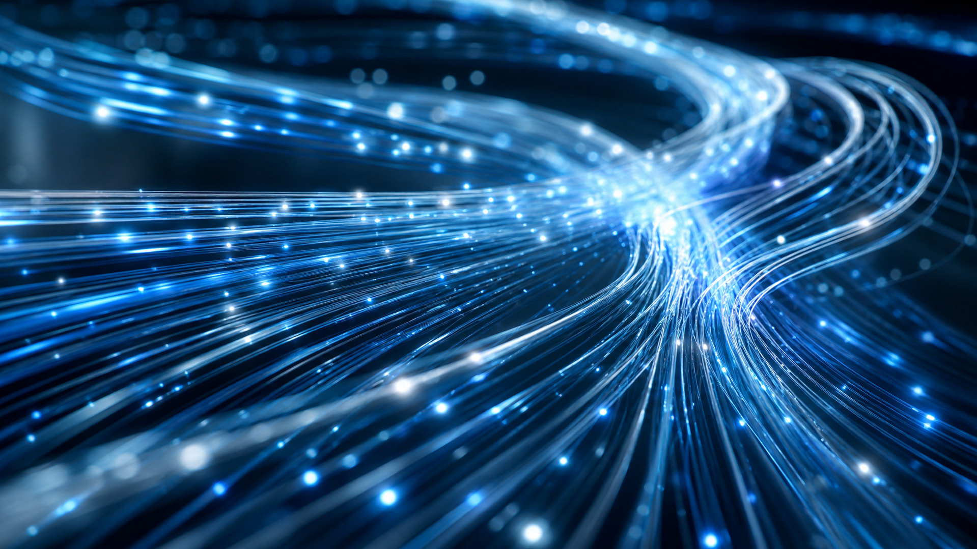Glowing bundle of blue fiber optic cables transmitting bright light particles, representing Optimum high-speed fiber internet.
