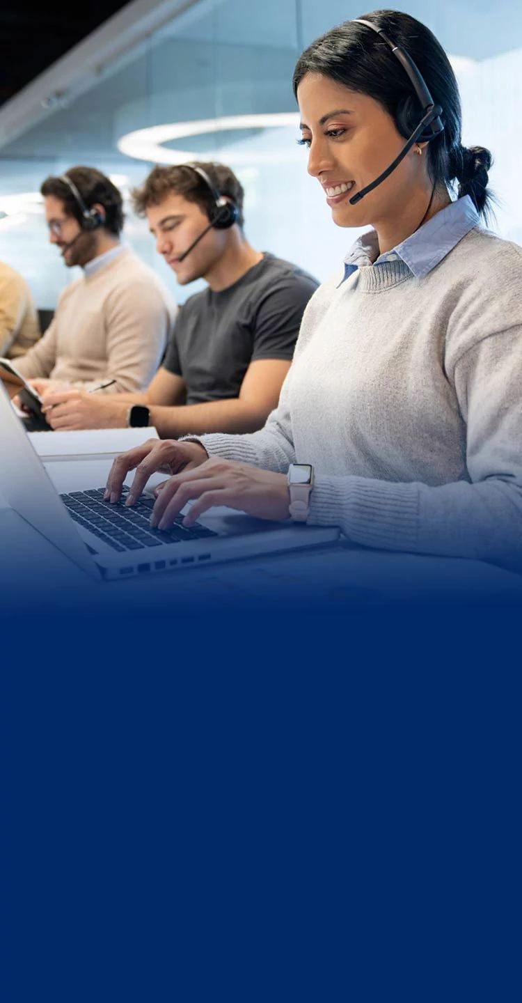 IT professionals and business team collaborating at a laptop, reviewing Secure Internet Plus cyber protection settings.