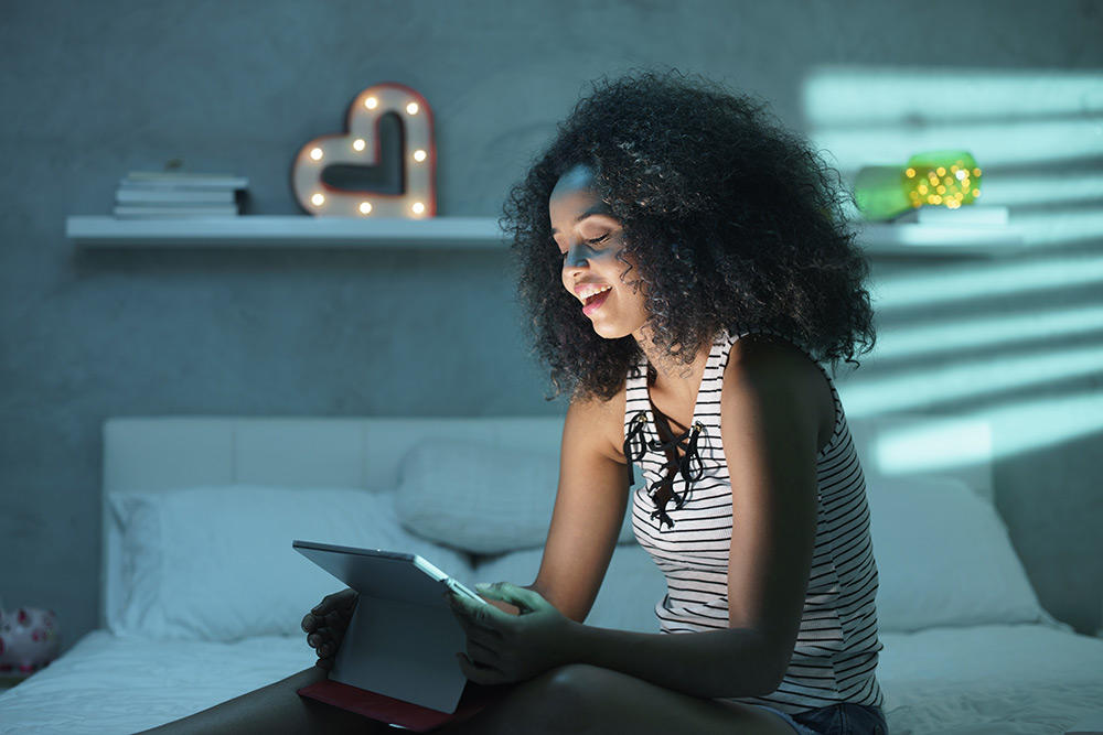 Woman using technology in her room